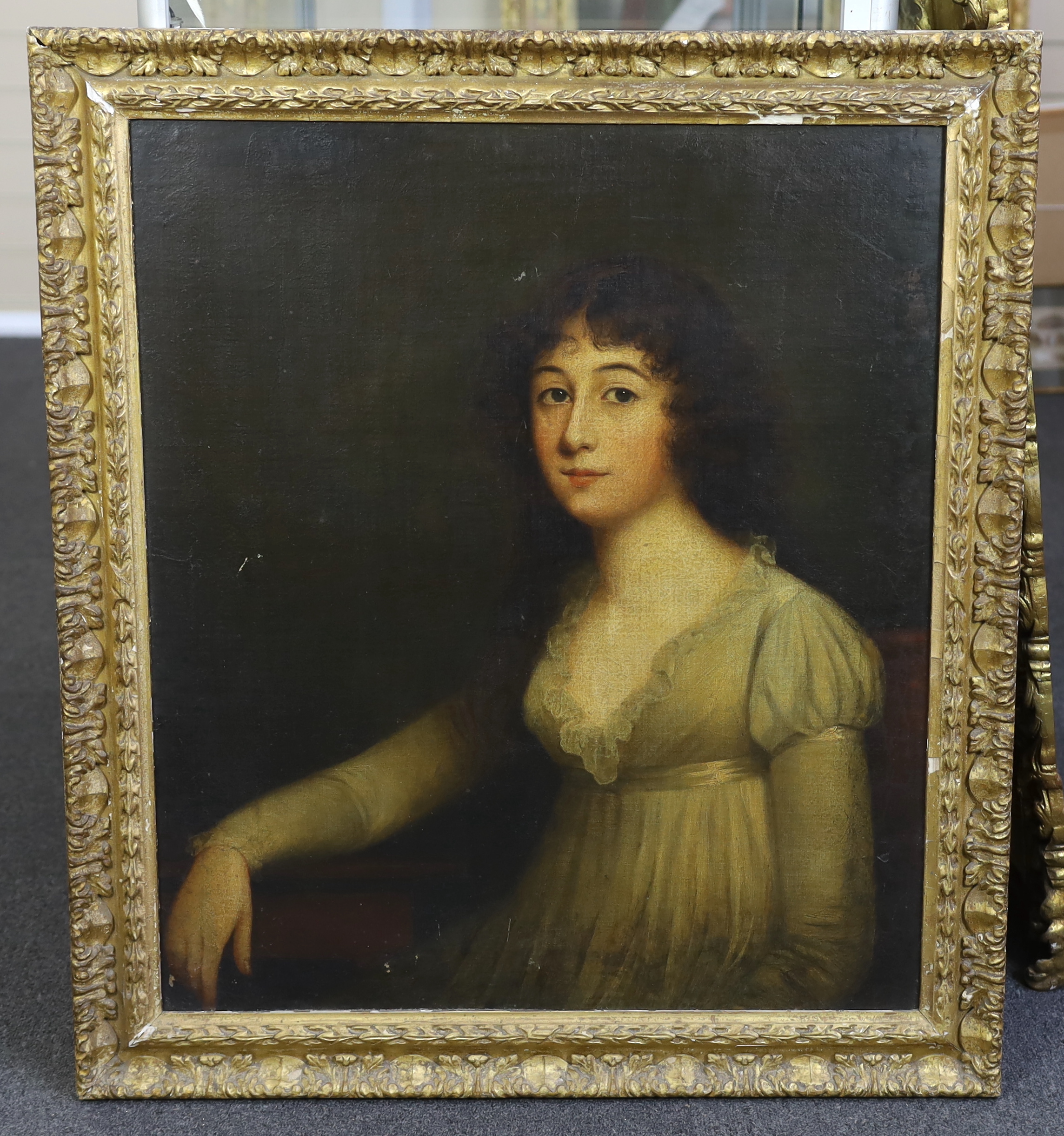 Late 18th century English School, Half length portrait of a young lady, seated with her arm resting upon a table, oil on canvas, 74 x 64cm